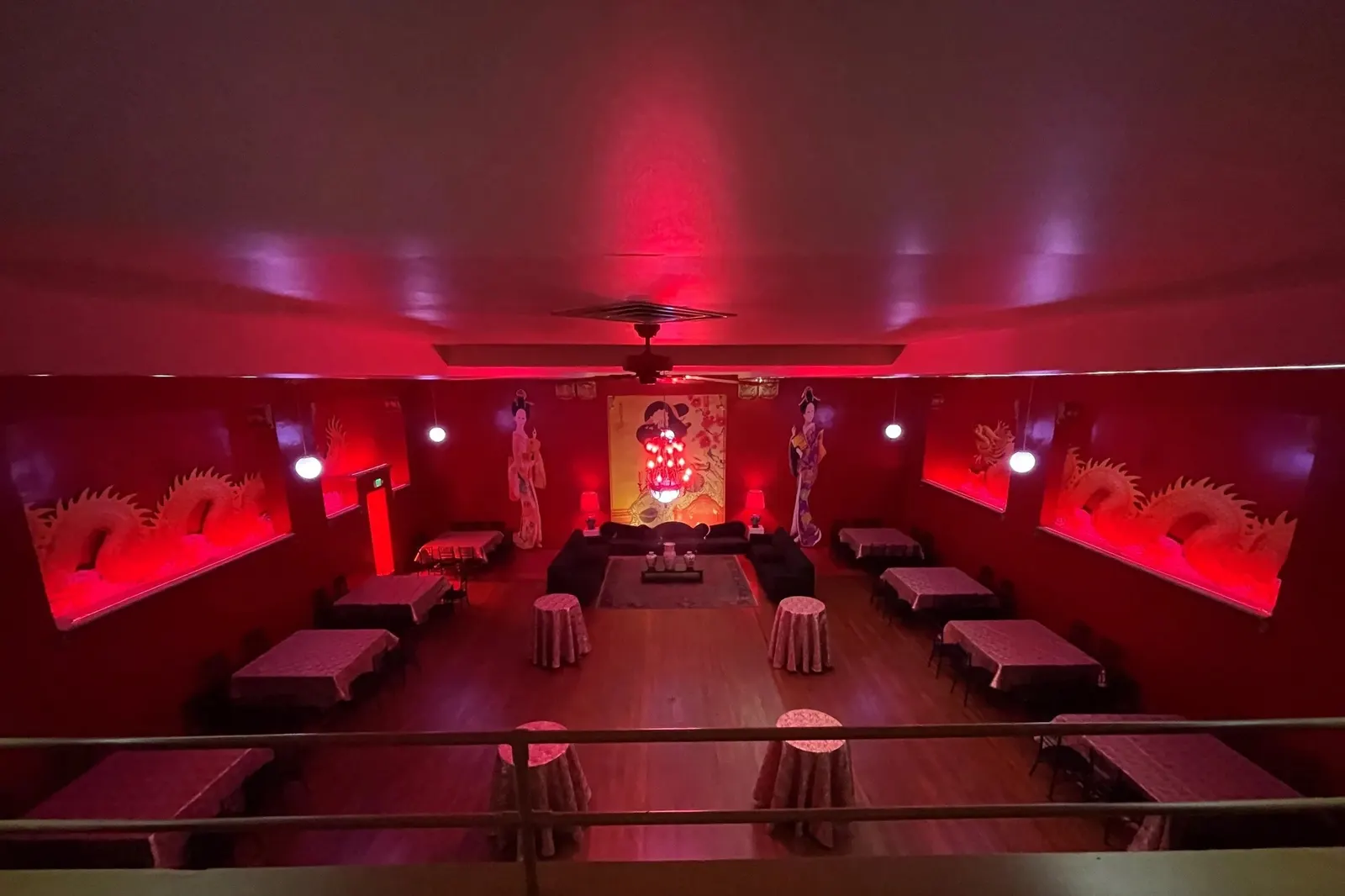 Downtown Compound, the Geisha Room, red-lit with a stage